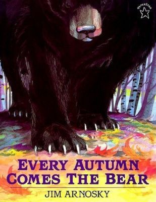 A large black bear walks through the forest on the nature picture book "Every Autumn Comes the Bear" by Jim Arnosky, a children's book featured on the best hibernation books for kids booklist.